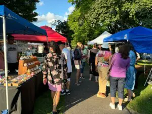 North Attleboro Farmers Market guests walking around at different vendor booths set up