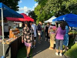 North Attleboro Farmers Market guests walking around at different vendor booths set up