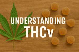 Understanding THCv with cannabis leaf and weed gummies on a wood background
